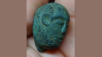 Find, An early Roman anthropomorphic cast copper alloy mount moulded into the form of a facing male head.